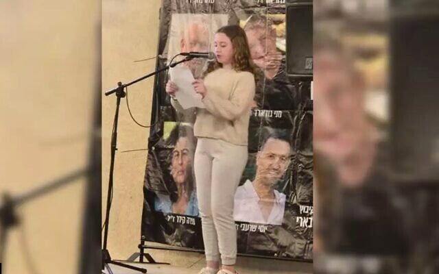 Former hostage Emily Hand speaks on May 21, 2025, at a Kibbutz Be'eri rally held for the hostages in the kibbutz's temporary quarters in Kibbutz Hazerim. (Courtesy Kibbutz Be'eri)